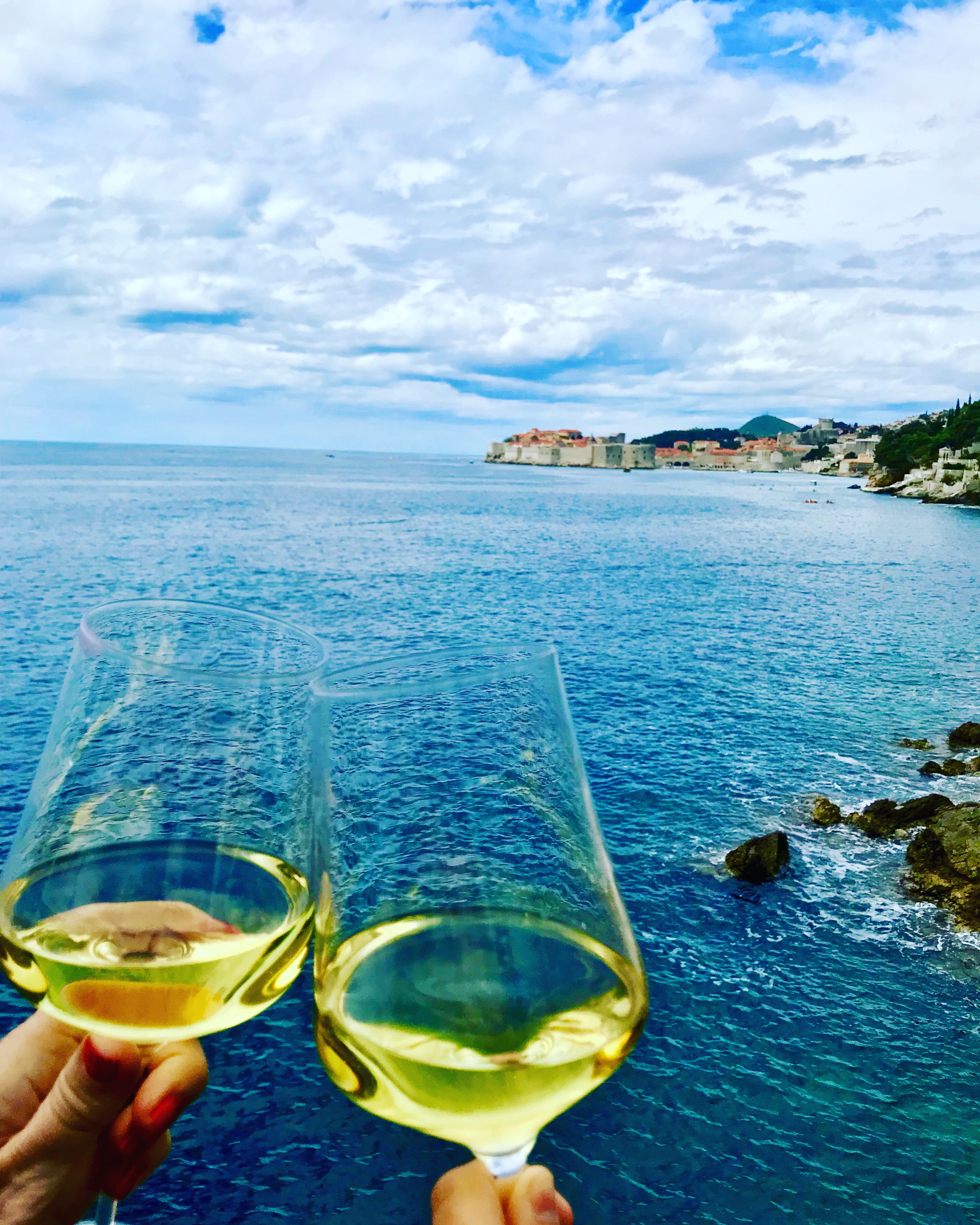 Tracy Dunn and Morgan Dunn enjoying their view from Villa Dubrovnik, and glass of wine, and a delicious lunch on the outside terrace.